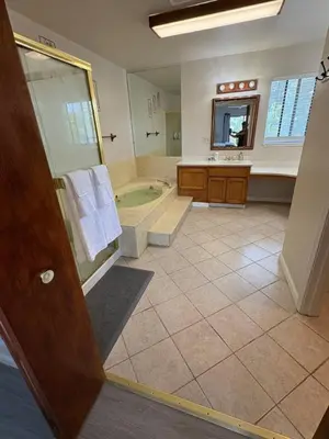 a large bathroom with a tub and a sink at Newly Renovated Lakefront with Dock in Bethel Island