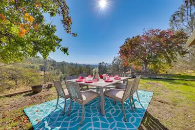 a table and chairs sitting on a patio at Scenic Yosemite Lakes Escape with Community Perks! in Coarsegold
