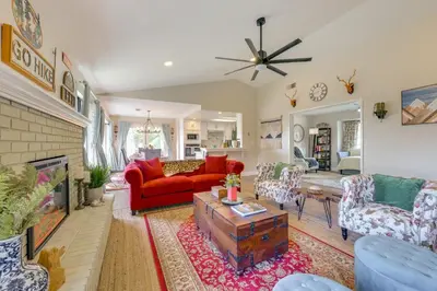 a living room with red furniture and a fireplace at Scenic Yosemite Lakes Escape with Community Perks! in Coarsegold