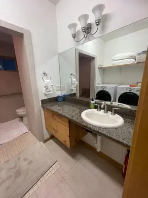 a bathroom with a sink and a mirror at Mountainside Family Chalet in Yosemite West