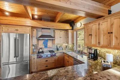 a kitchen with wooden cabinets and a stainless steel refrigerator at Bella Casa - North Lake Tahoe in Tahoe City
