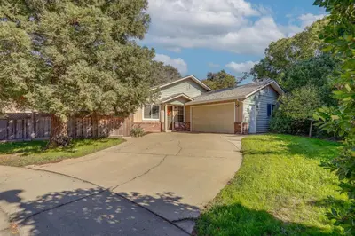 a house with a tree and a driveway at Pet-Friendly Yard! Home 3 Mi to Sky River Casino in Elk Grove