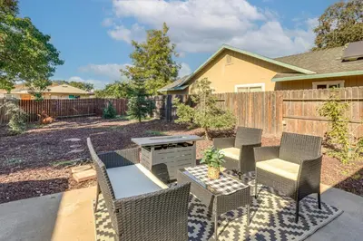 a backyard with chairs and a table and a grill at Pet-Friendly Yard! Home 3 Mi to Sky River Casino in Elk Grove