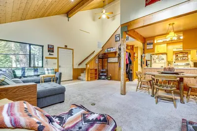 a living room with a couch and a table at 1 Mi to Skiing! Cabin Hideaway on June Lake Loop in June Lake