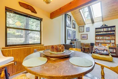 a room with a table with a cake on it at 1 Mi to Skiing! Cabin Hideaway on June Lake Loop in June Lake