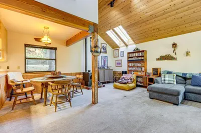 a living room with a couch and a table at 1 Mi to Skiing! Cabin Hideaway on June Lake Loop in June Lake