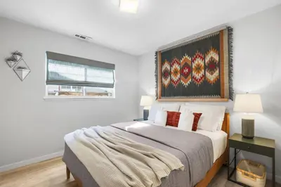 a bedroom with a bed and a painting on the wall at Stellars Jay Getaway Pet Friendly in City of SLT in South Lake Tahoe