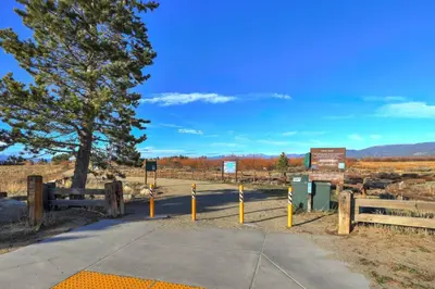a road with a tree and fence and a sign at Stellars Jay Getaway Pet Friendly in City of SLT in South Lake Tahoe