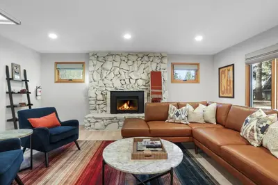a living room with a couch and a fireplace at Stellars Jay Getaway Pet Friendly in City of SLT in South Lake Tahoe