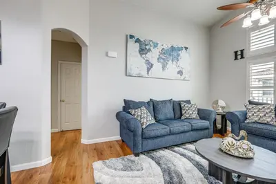 a living room with two blue couches and a table at Extended-Stay Ready! Elk Grove Unit with Pool Access in Elk Grove