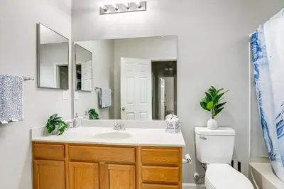 a bathroom with a sink and a toilet and a mirror at Extended-Stay Ready! Elk Grove Unit with Pool Access in Elk Grove
