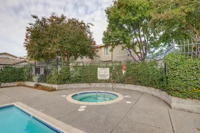 a small swimming pool with a sign next to a fence at Extended-Stay Ready! Elk Grove Unit with Pool Access in Elk Grove