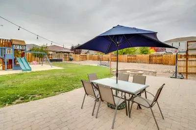 a table and chairs with an umbrella and a playground at Family-Friendly Retreat with Playground in Reno! in Reno