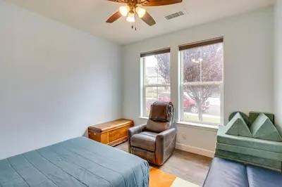a bedroom with a bed and a chair and a window at Family-Friendly Retreat with Playground in Reno! in Reno