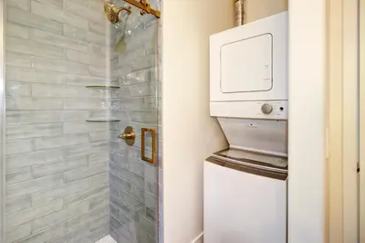 a shower with a washer and dryer in a bathroom at Modern Cozy and contemporary in Ione
