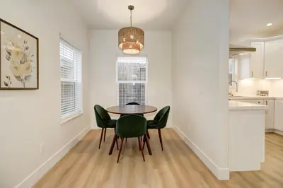 a dining room with a table and green chairs at Modern Cozy and contemporary in Ione