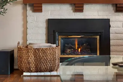 a living room with a fireplace and two chairs at Family 4BR Home with Patio by Willowcreek Park in Sparks