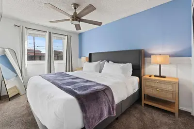 a bedroom with a large bed and a ceiling fan at Family 4BR Home with Patio by Willowcreek Park in Sparks