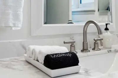 a bathroom sink with a black and white towel holder at Family 4BR Home with Patio by Willowcreek Park in Sparks