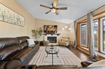 a living room with a leather couch and a fireplace at Family 4BR Home with Patio by Willowcreek Park in Sparks