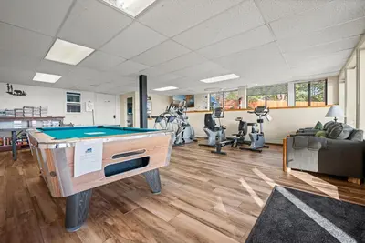 a gym with a pool table and exercise equipment at Tahoe Edgelake Beach Club by Coolvacay in Tahoe Vista