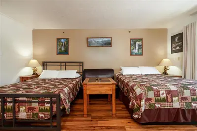 a hotel room with two beds and a table at (A108) Studio Condominiums in Yosemite West