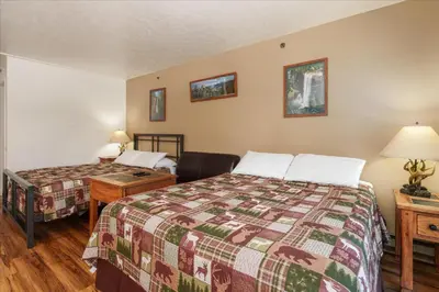 a hotel room with two beds and a desk with a bed sidx sidx sidx sidx at (A108) Studio Condominiums in Yosemite West