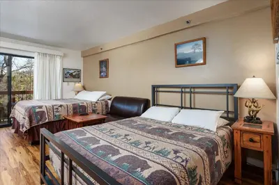 a hotel room with two beds and a window at (A111) Studio Condominiums in Yosemite West