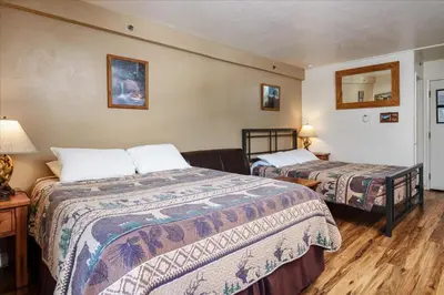 a hotel room with two beds and a table at (A111) Studio Condominiums in Yosemite West