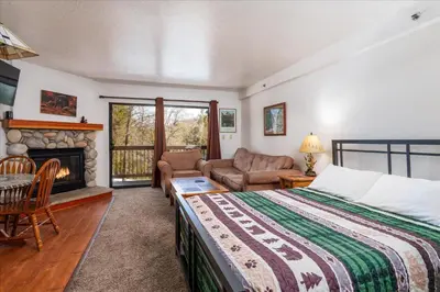 a bedroom with a bed and a fireplace at (A109) Studio Condominiums in Yosemite West