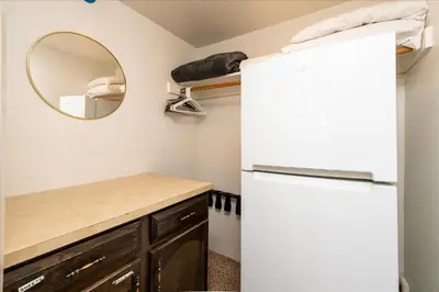 a kitchen with a refrigerator and a mirror at (A109) Studio Condominiums in Yosemite West