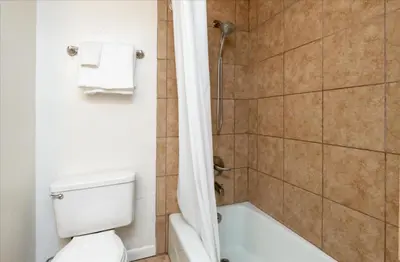 a bathroom with a toilet and a tub and a shower at (A109) Studio Condominiums in Yosemite West