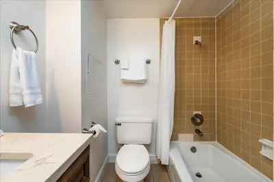 a bathroom with a toilet and a sink and a tub at (A202) Loft Condominiums in Yosemite West