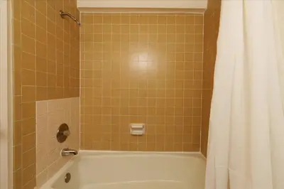 a bathroom with a bath tub with a shower curtain at (A202) Loft Condominiums in Yosemite West