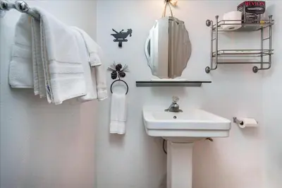 a bathroom with a sink and a mirror and towels at (A204) Loft Condominiums in Yosemite West