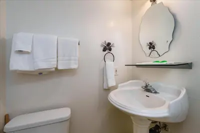 a bathroom with a sink and a toilet and a mirror at (A204) Loft Condominiums in Yosemite West