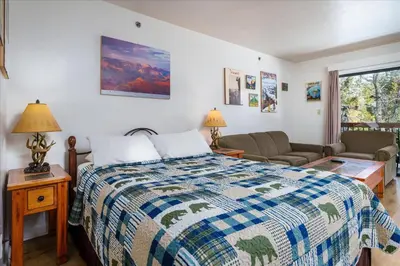 a bedroom with a bed and a couch at (A110) Studio Condominiums in Yosemite West