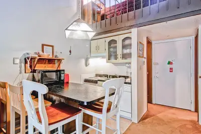 a kitchen with a table and chairs in a kitchen at (A203) Loft Condominiums in Yosemite West