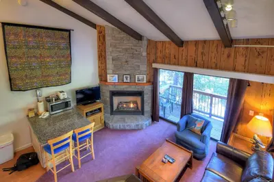 a living room with a fireplace and a couch at (A207) Loft Condominiums in Yosemite West