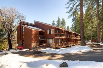 a house in the woods in the snow at (A207) Loft Condominiums in Yosemite West