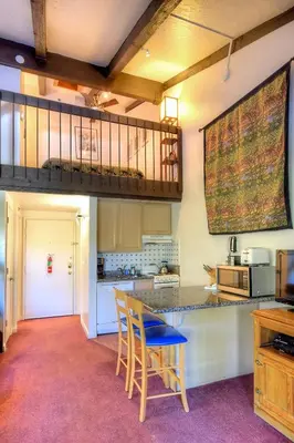 a kitchen with a table and chairs in a room at (A207) Loft Condominiums in Yosemite West