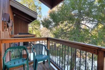 two chairs sitting on the deck of a cabin at (A207) Loft Condominiums in Yosemite West