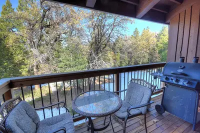 a balcony with a table and chairs and a grill at (A211) Loft Condominiums in Yosemite West