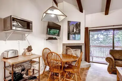 a kitchen with a table and chairs and a dining room at (B207) Loft Condominiums in Yosemite West