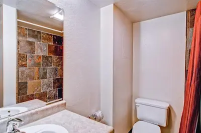 a bathroom with a white toilet and a sink at (B211) Loft Condominiums in Yosemite West