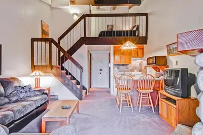 a living room with a couch and a table with chairs at (B211) Loft Condominiums in Yosemite West