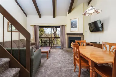 a living room with a table and a dining room at (B208) Loft Condominiums in Yosemite West