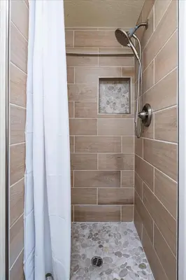 a bathroom with a shower with a shower curtain at (B208) Loft Condominiums in Yosemite West