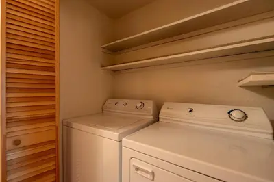 a white laundry room with a washer and dryer at Creekside Chalet Stay for 6 in Kings Beach