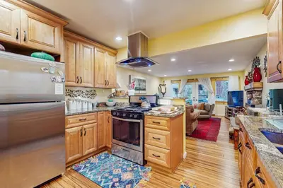 a kitchen with wooden cabinets and a stove top oven at Colorado Pines Retreat in South Lake Tahoe